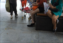 Women waiting with cellphones